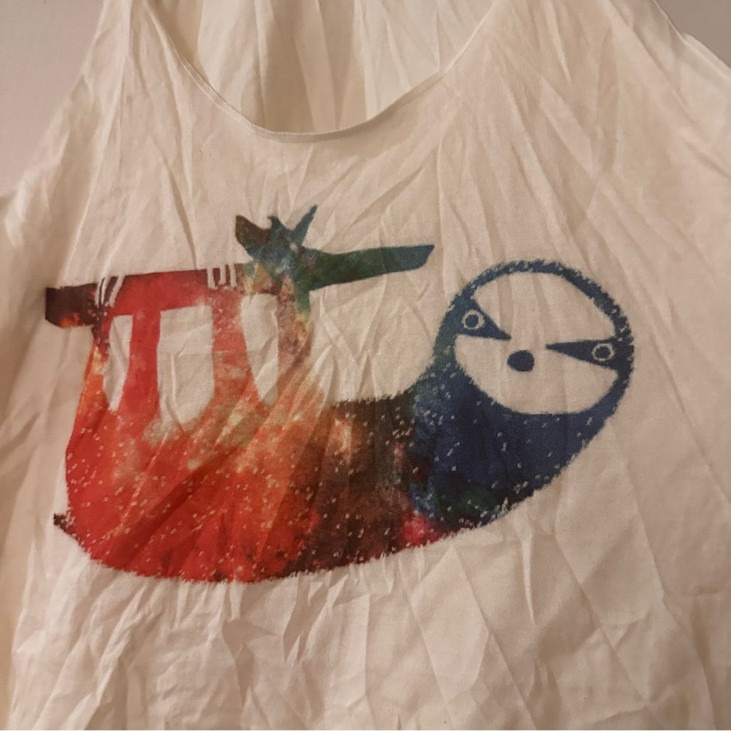 Cream tank with colorful sloth graphic